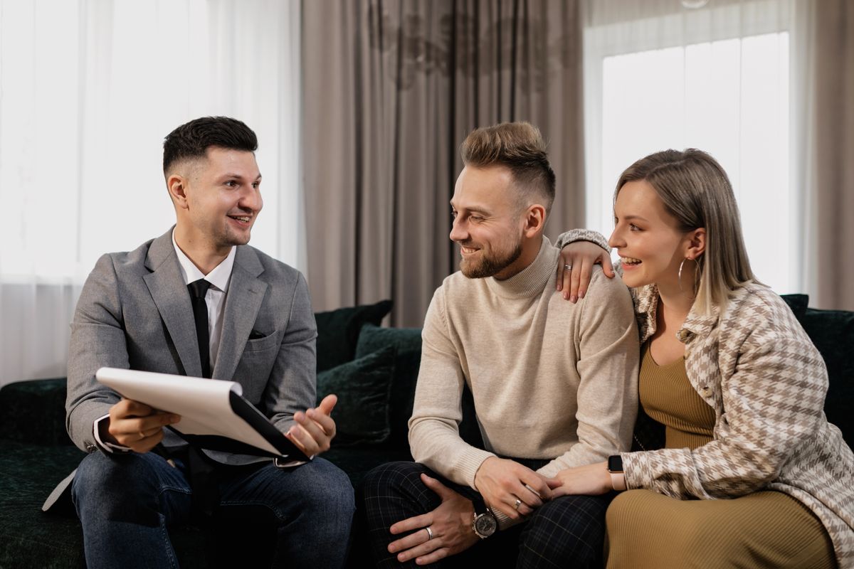 A realtor sitting with a couple, talking through their questions